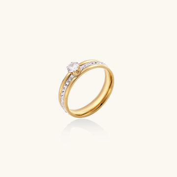 Gold-plated double-band ring with center rhinestone solitaire and channel-set stones on white background